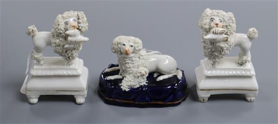 A pair of Staffordshire porcelain figures of poodles and a similar poodle group, c.1830-50, H. 6.2 and 9cm